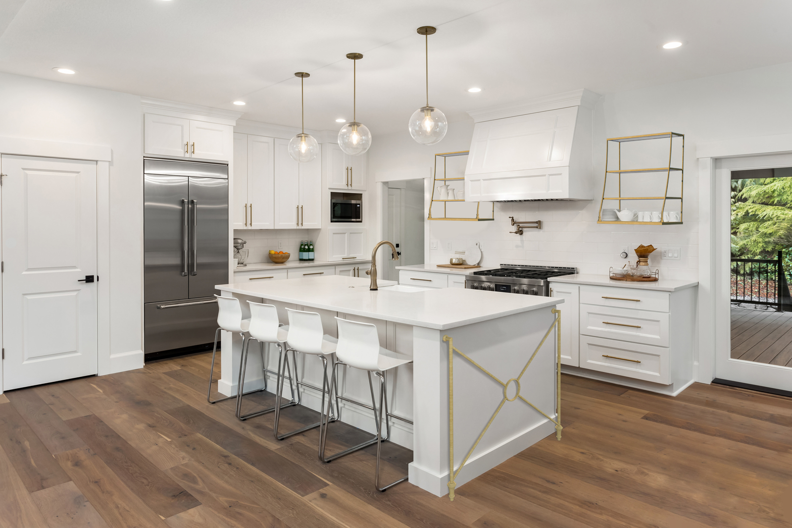 gold metal shelving in an all white kitchen.