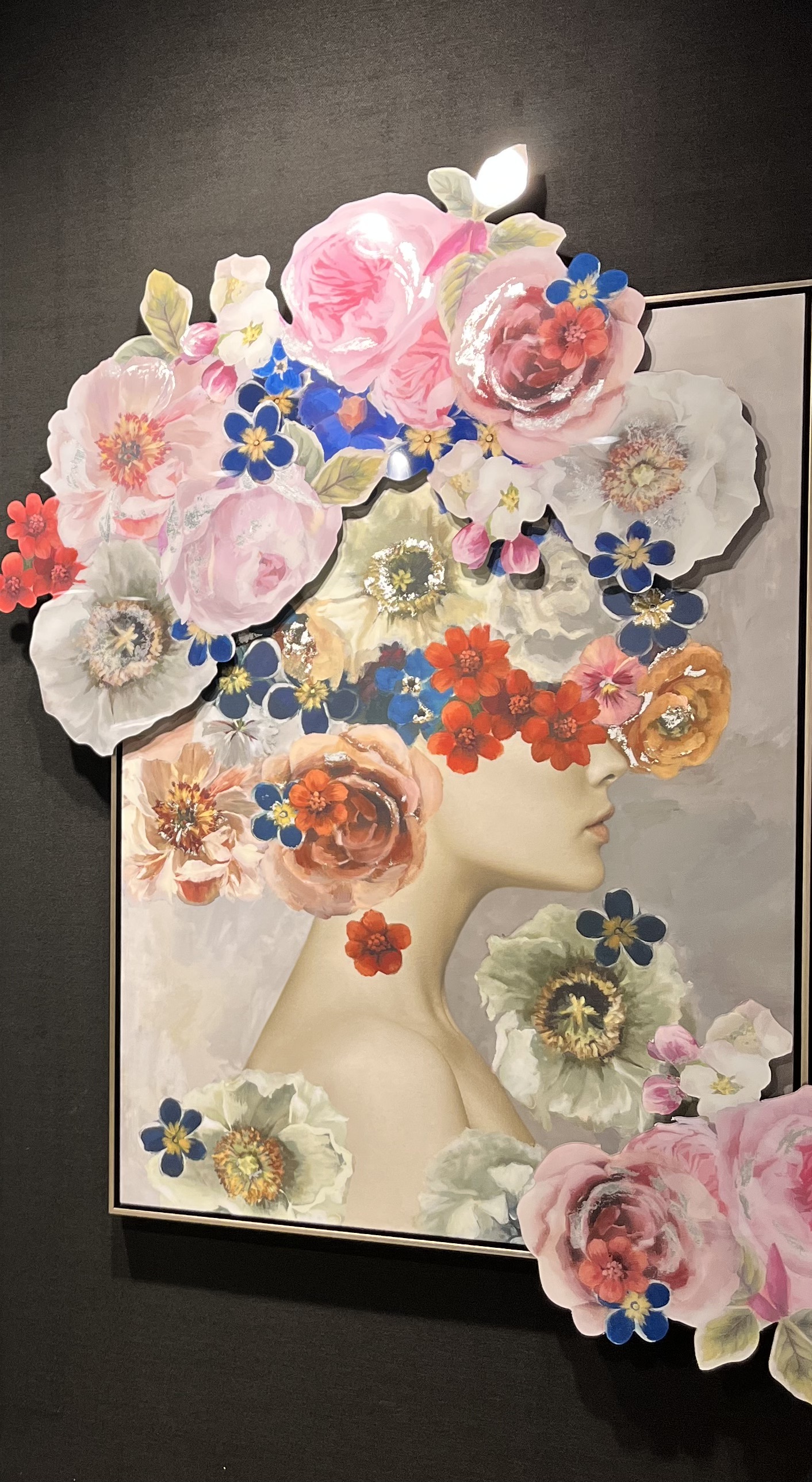 Artwork with a ladies head covered in flowers that jump off the page