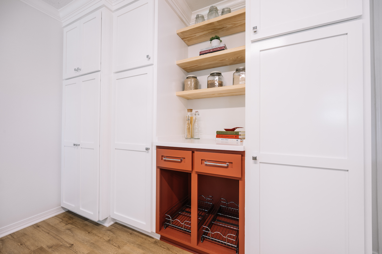 white and red cabinets with vegetable storage and floating shelves