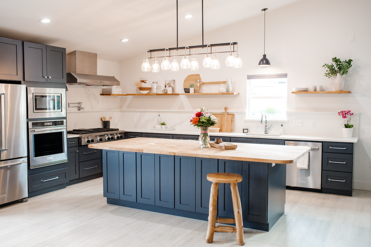 kitchen with dark grey cabinets, black lighting, and butcher block and quartz countertop