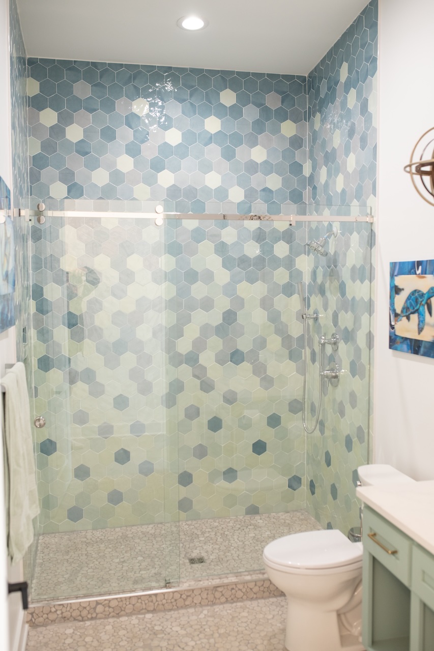 hexagon shower tiles in different colors to mimic a waterfall